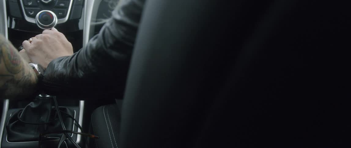 A person rides in the front seat of a car