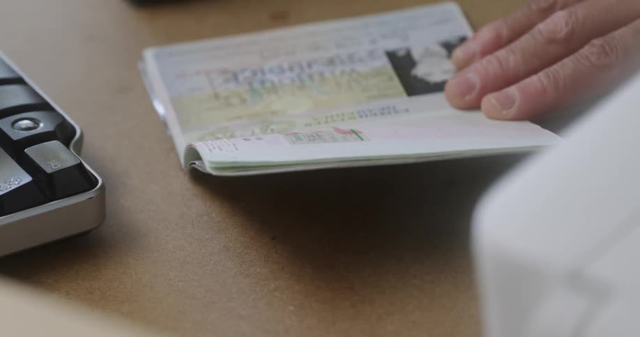 A person stamps a passport