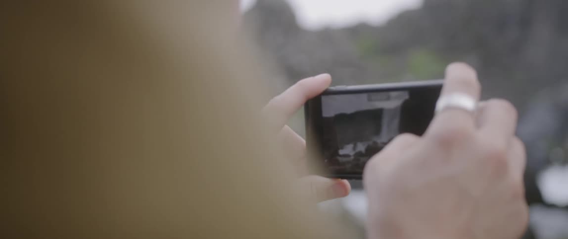 A man takes a picture with a smartphone