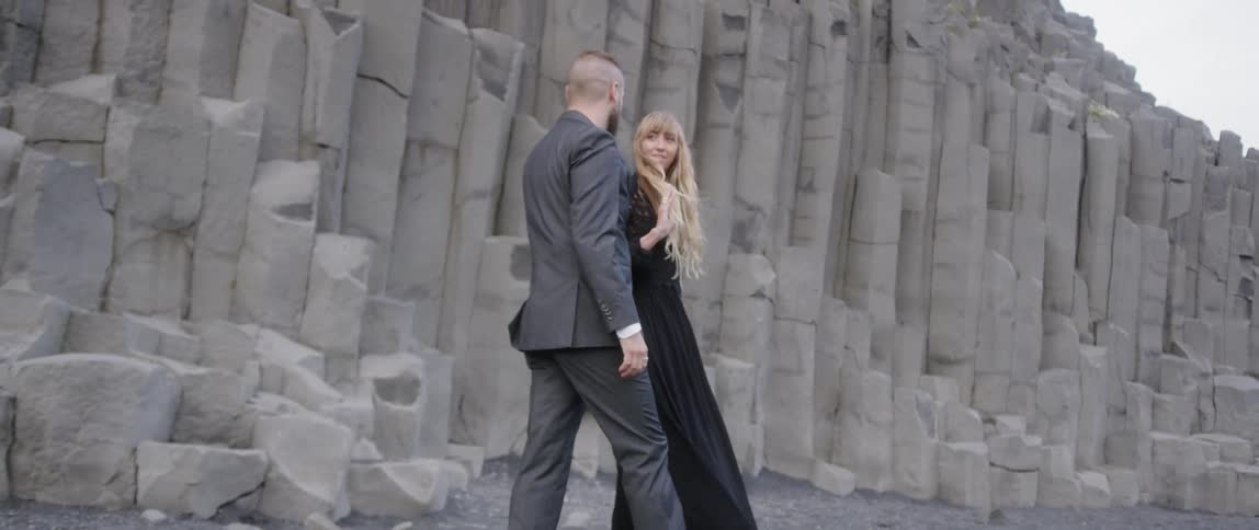 The man walks up to kiss the woman