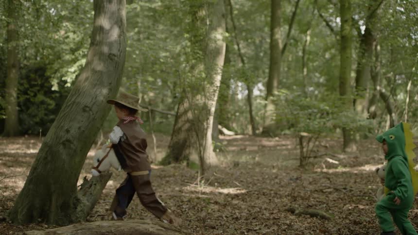 Boys In Costumes Playing In Forest
