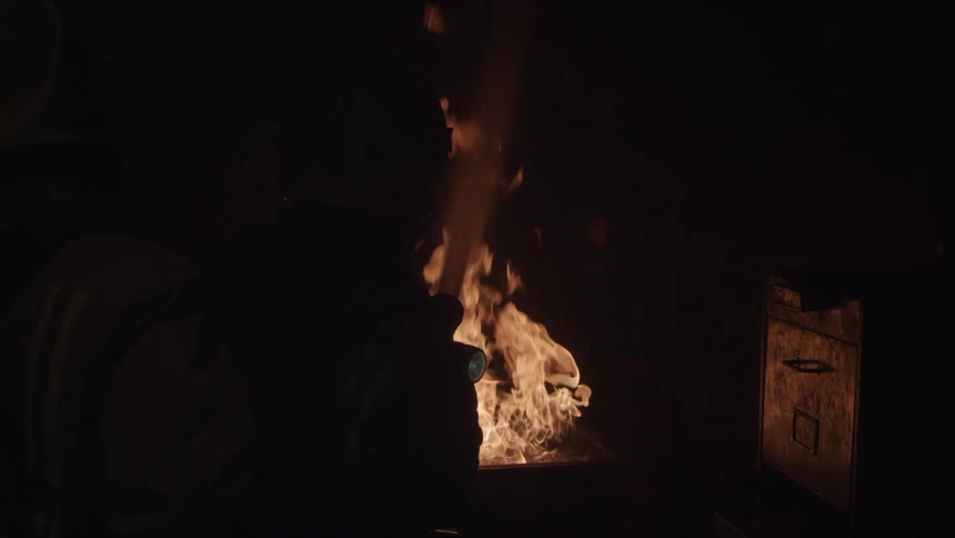 Fire burns brightly outside at night