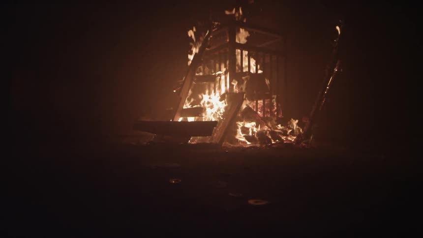 A structure is on fire at night