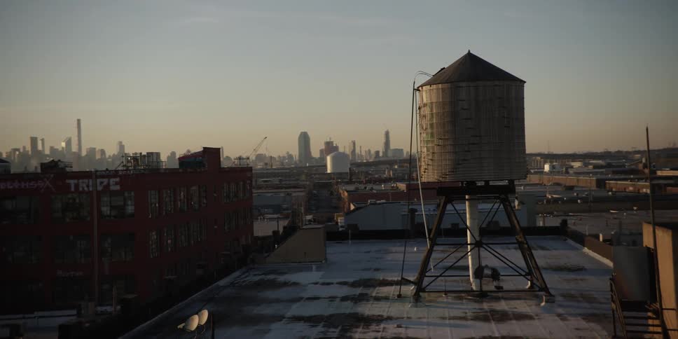View of a some roofs in a city at dusk