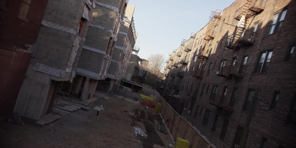 An aerial view between an old apartment complex and a new complex being built