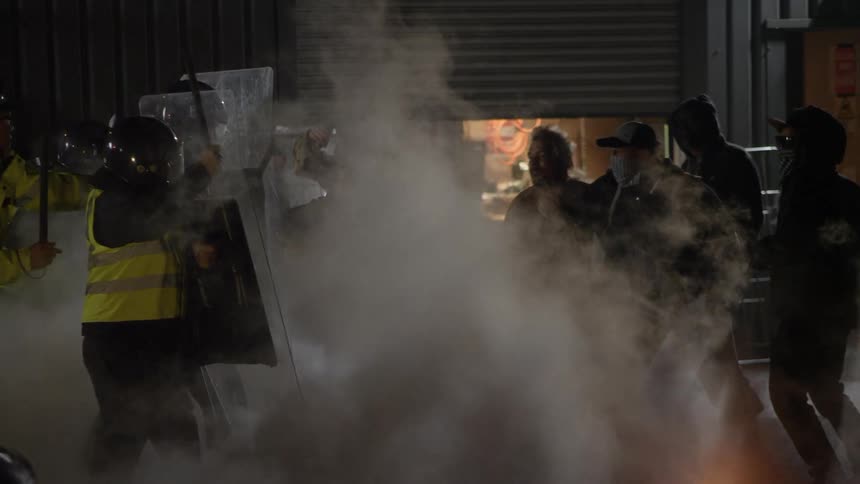 Rioters attack police with shields and batons