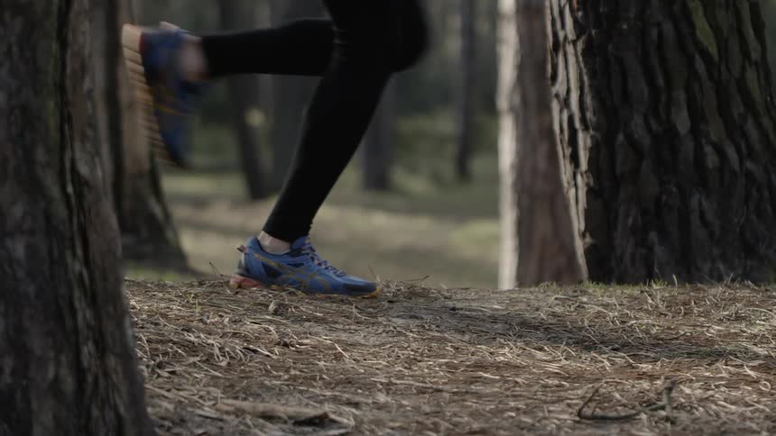 The person runs past the trees
