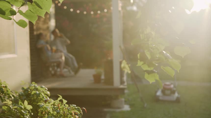 A man and woman relax on a front porch