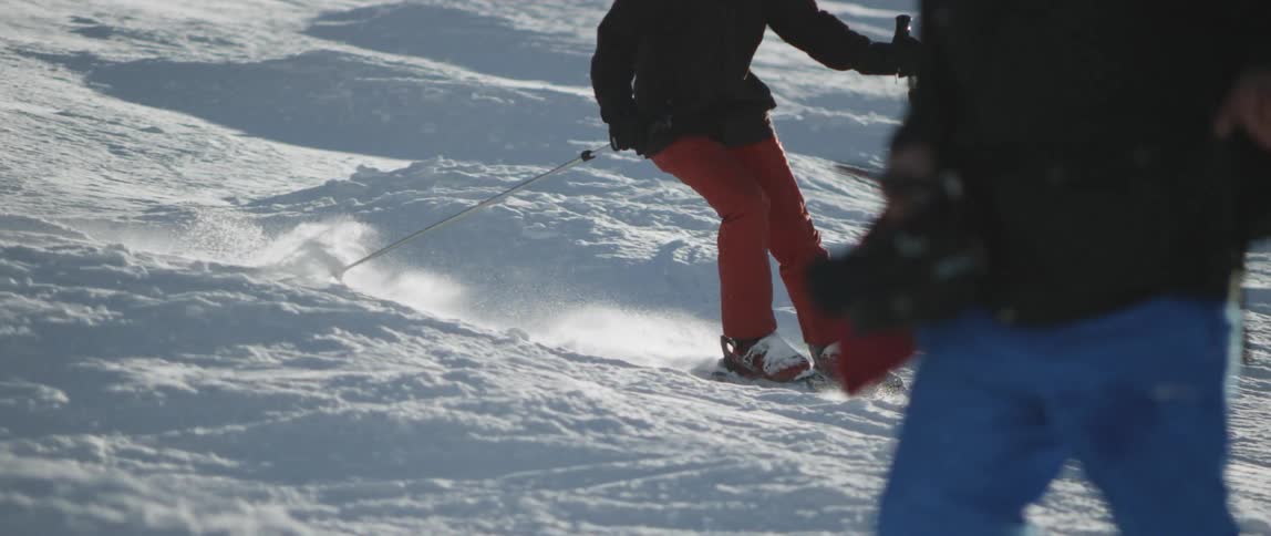 The person turns going down the ski slope