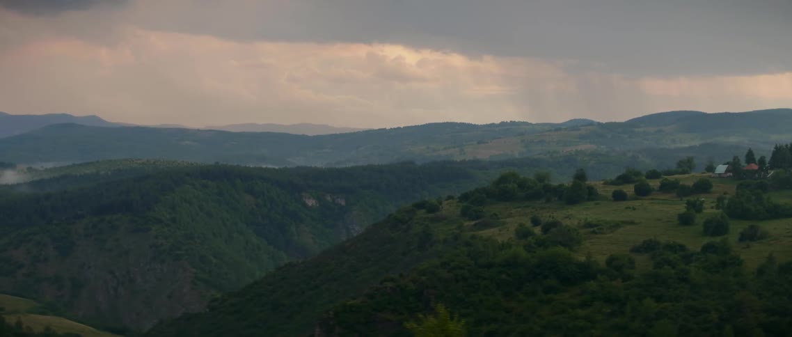 The hills are covered with green and fog