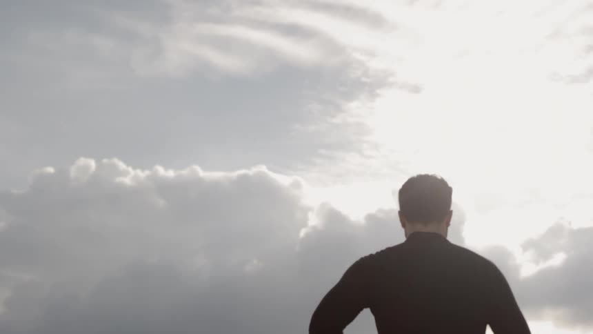 The man is jogging on a cloudy day