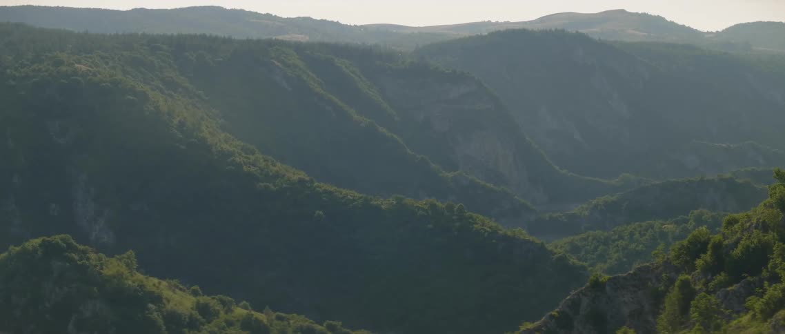 The mountain range is covered with fog