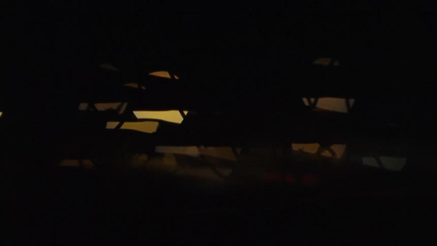The lights are blurry behind the fence
