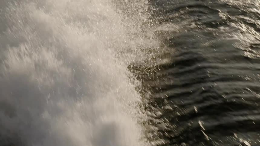 The boat splashes water behind as it travels