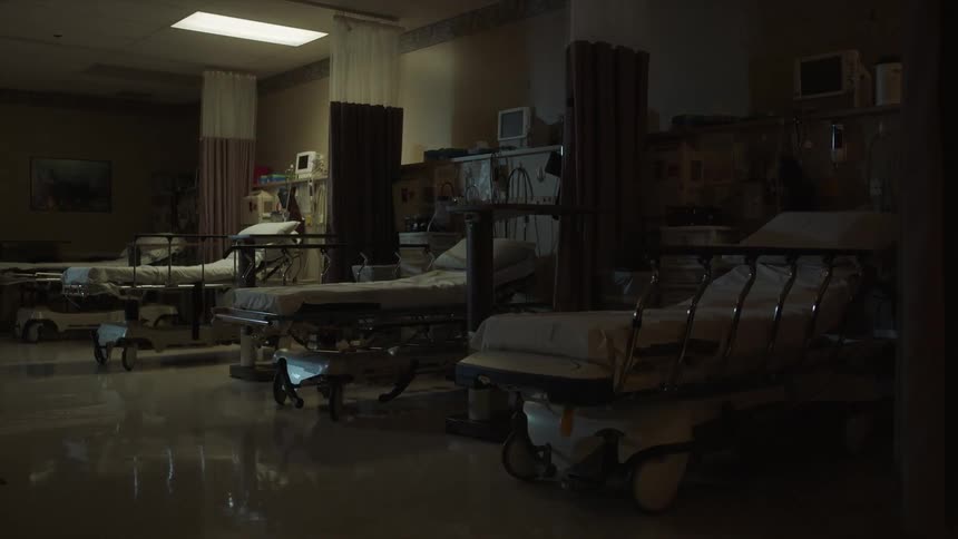 Empty hospital beds are shown