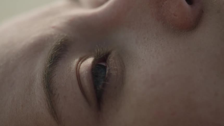Woman closes her eyes outside on a sunny day