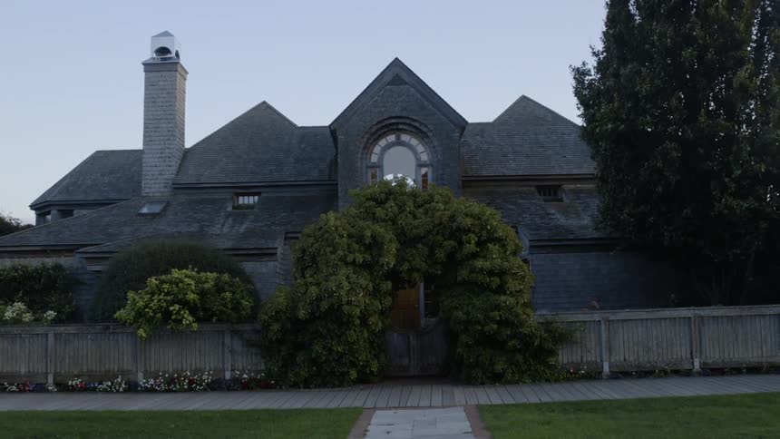 The house ahead is lined with a fence