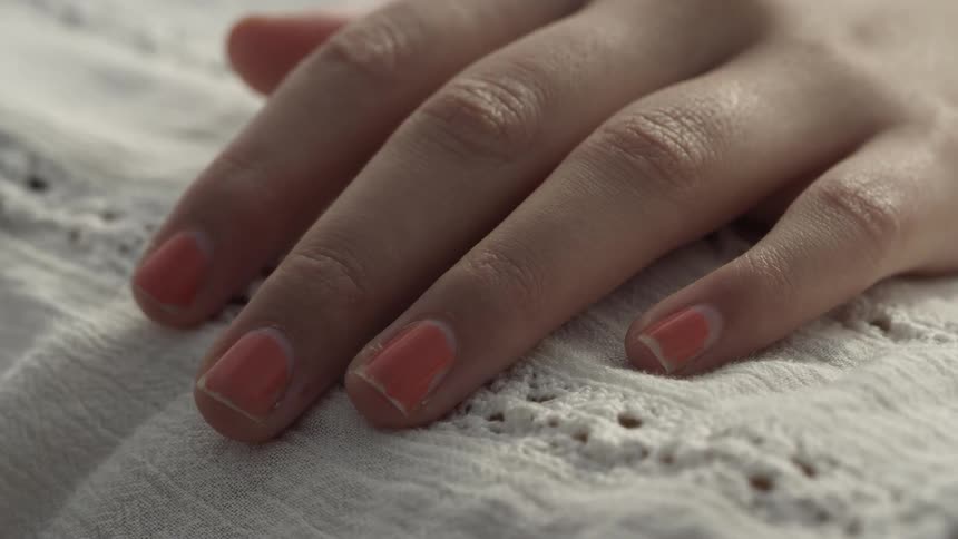 The person's hand is on the blanket