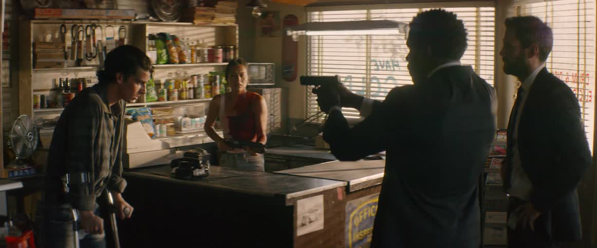 People are pointing guns at each other in the store