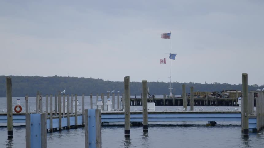 The flags fly high above the pier