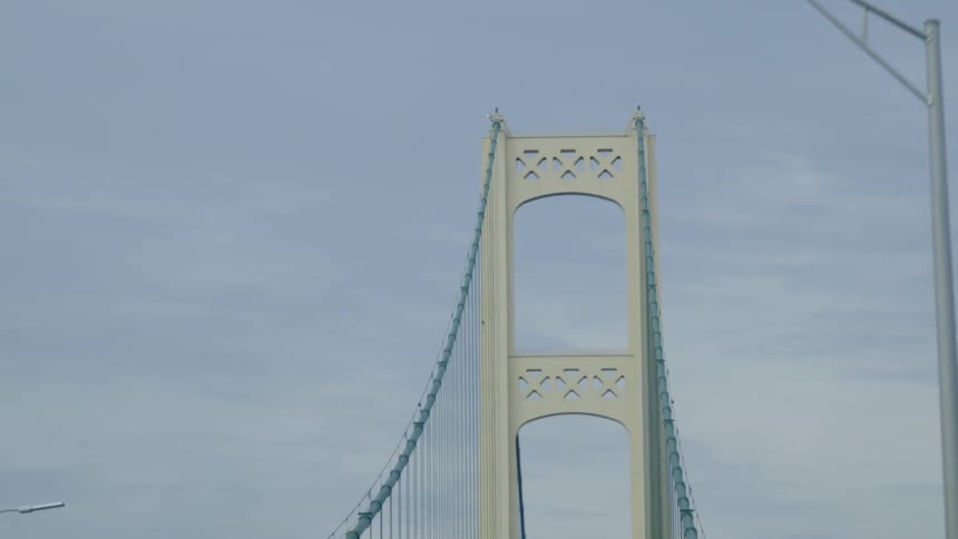 The bridge is tall with many wires holding it up