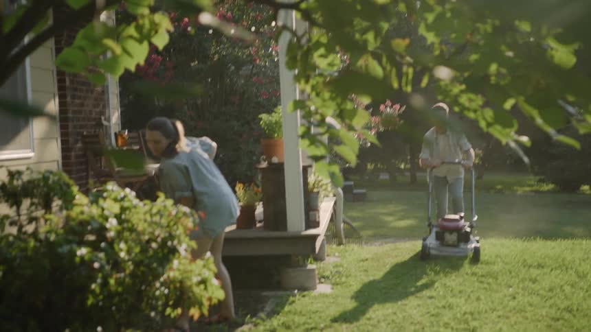 The two people work on the landscaping in the yard