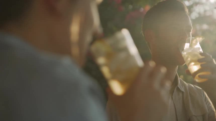 Man and woman talk to each other and drink iced tea