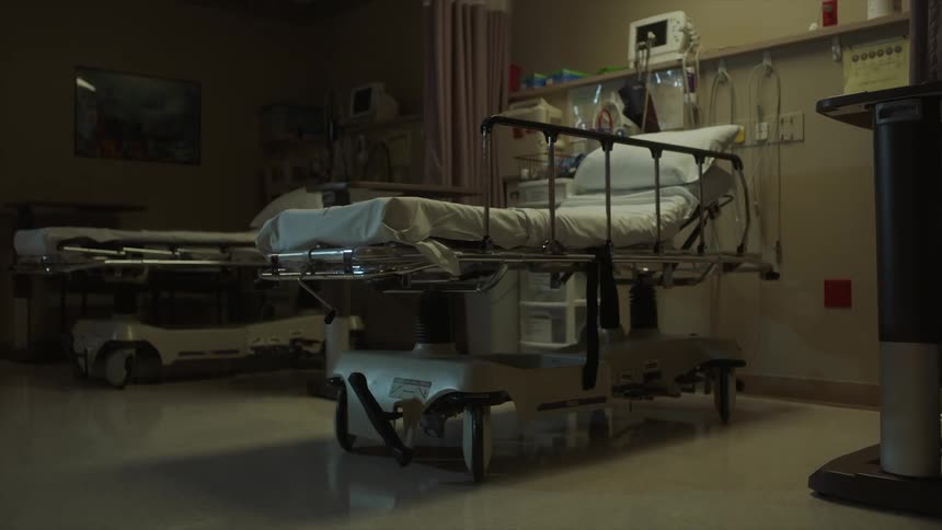 Beds lay empty in a hospital room