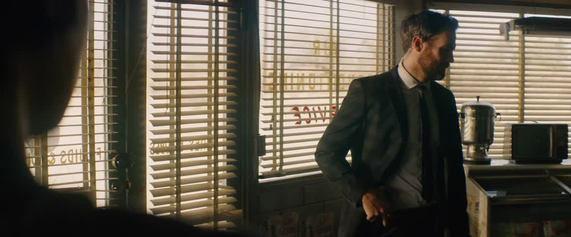The man holds his gun by his waist