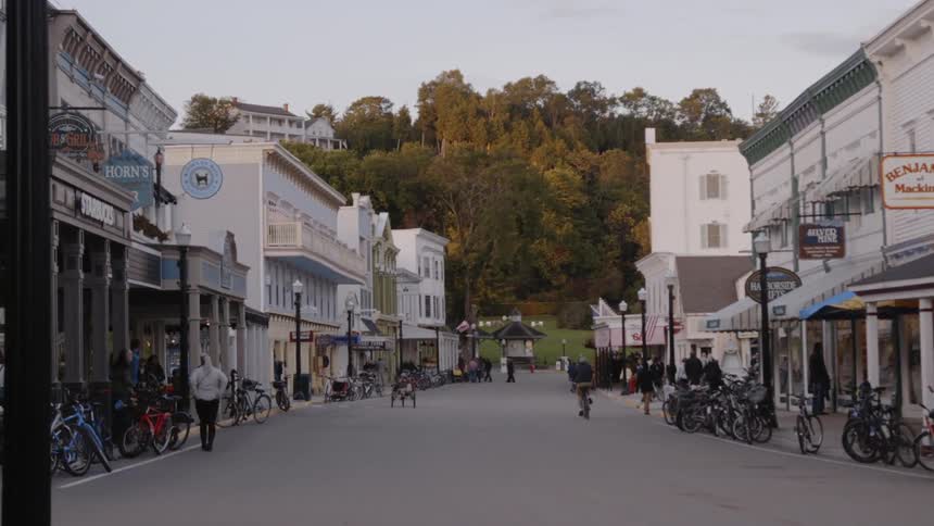 The people walk and ride bicycles in town