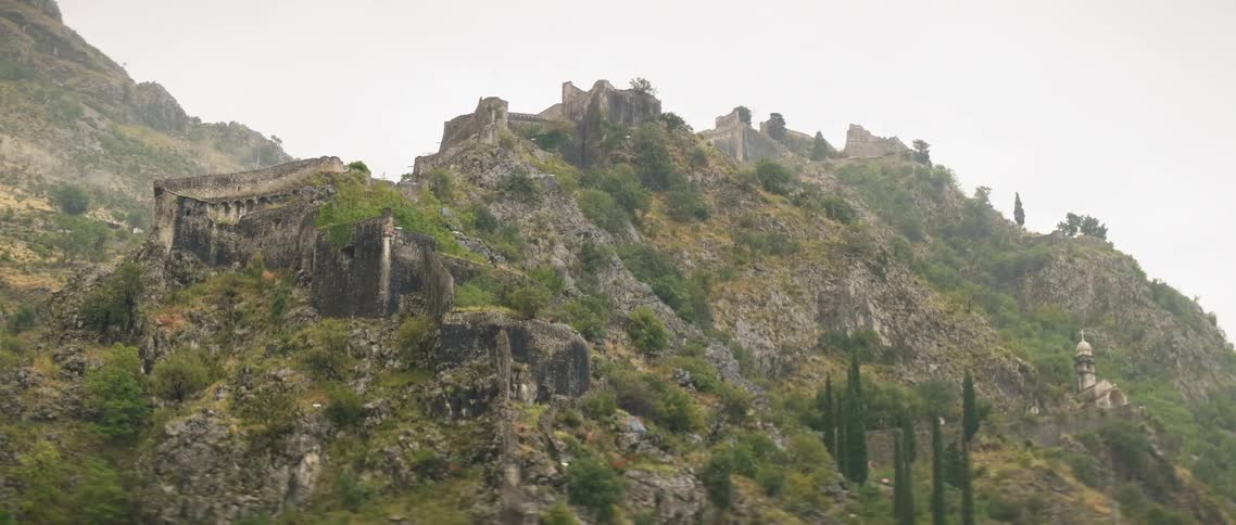 The hill is covered with jagged rocks and grass