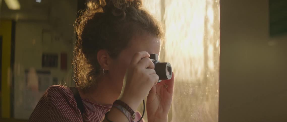 The woman takes pictures from inside the train