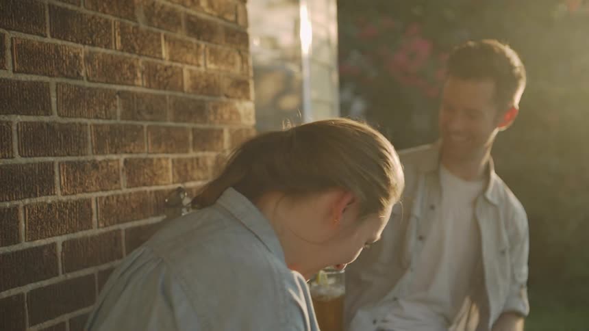 Man Pours Last Drops of Tea into Woman's Glass