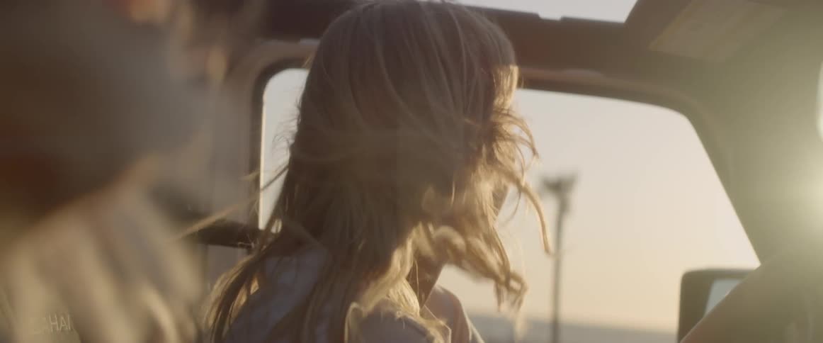 The woman laughs as she drives the vehicle