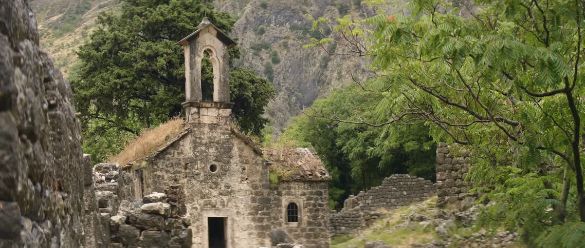 The stone building sits by the mountain
