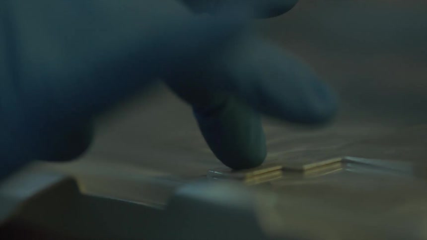 A gloved hand pressing keys on a keyboard