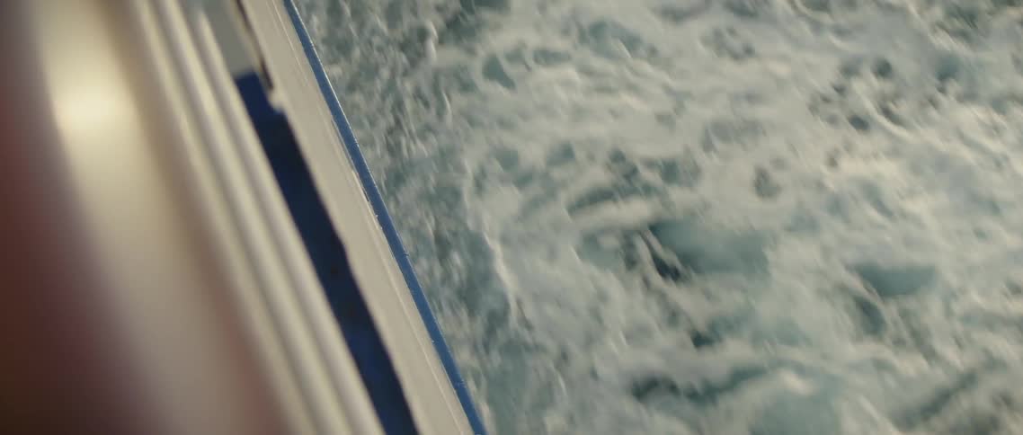 Water rushes underneath a boat