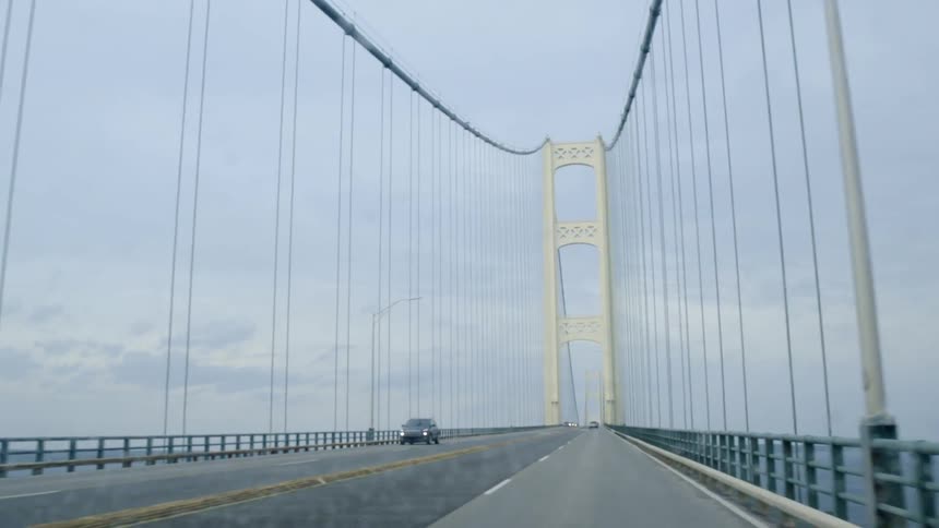 The bridge has some cars traveling over it