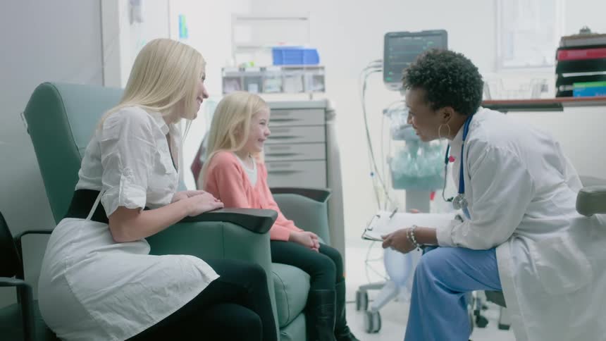 A doctor has a session with a parent and her daughter