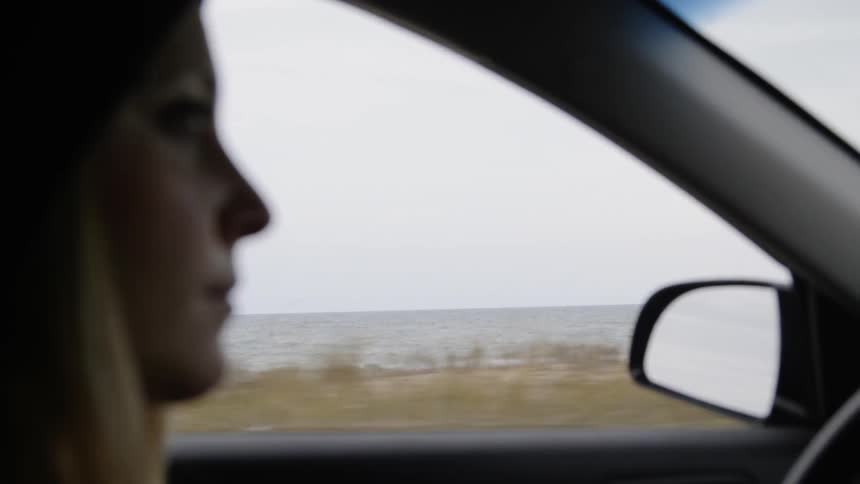 The woman is driving a car
