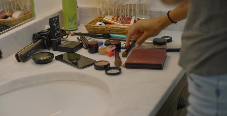 The woman stands in front of her sink