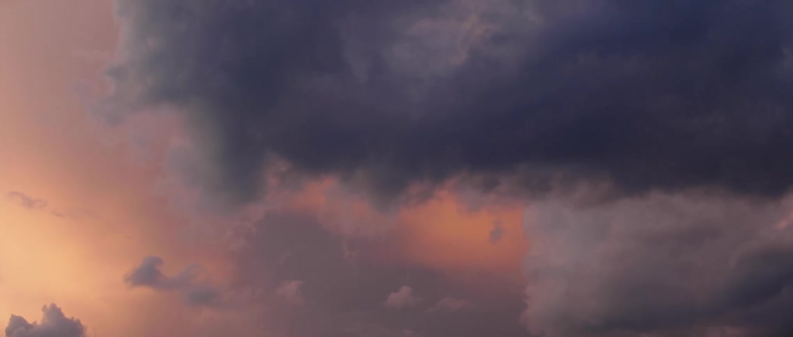 The heavy storm clouds cover the sky at sunset