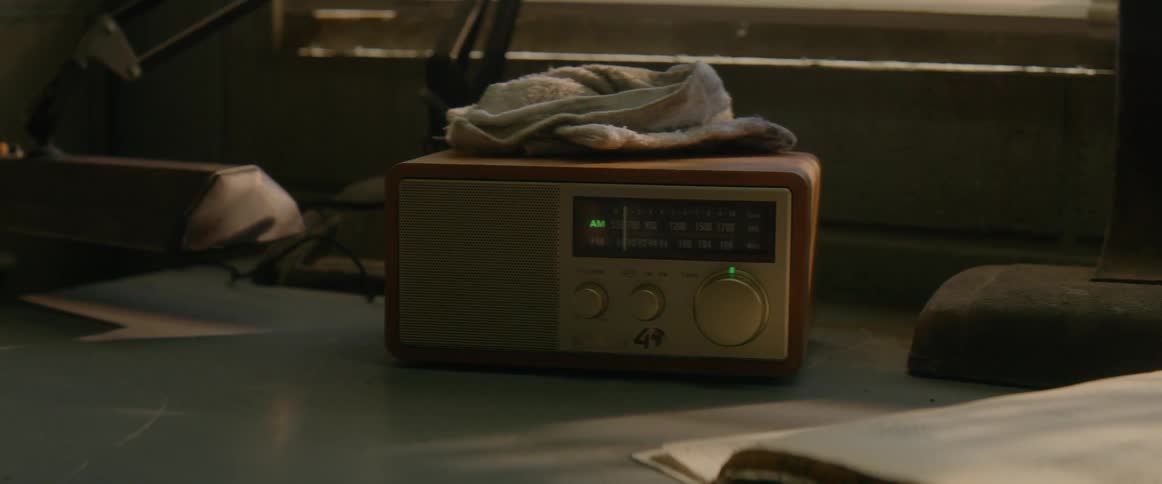 A dirty white rag sits on top of a transistor radio