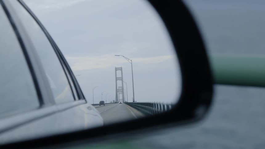 The vehicle is traveling over the bridge