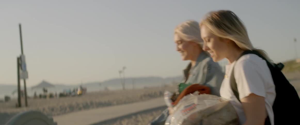 The two women talk as they walk to the beach