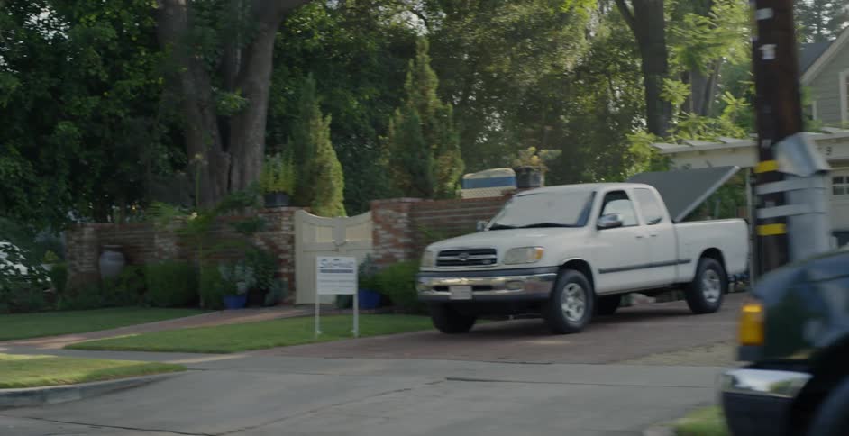 Trucks and cars sit parked in a residential neighborhood