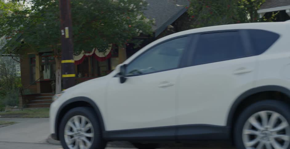 Vehicles parked on the road in a neighborhood