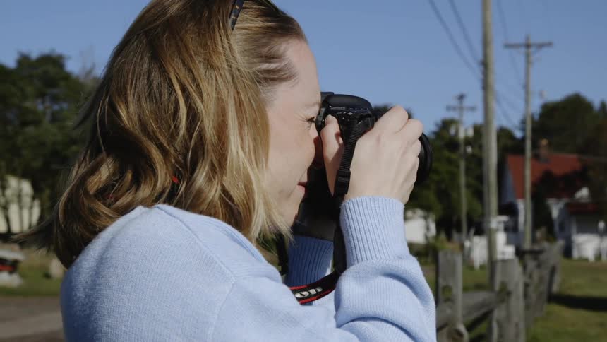 The woman takes a photo and checks the camera