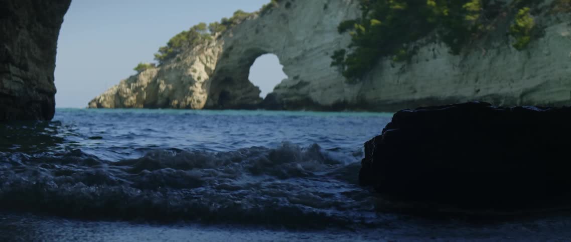 Ocean water ripples and flows around rocks