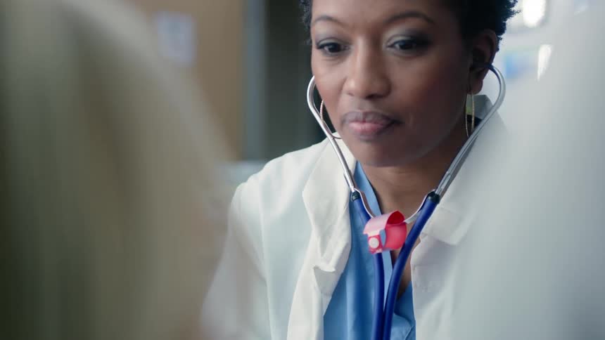 A doctor uses a stethoscope